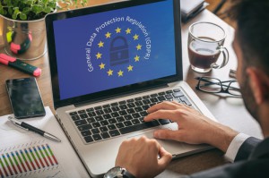 Man working on laptop with GDPR and EU symbols superimposed